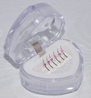 A heart shaped box with an array of dental floss inside.