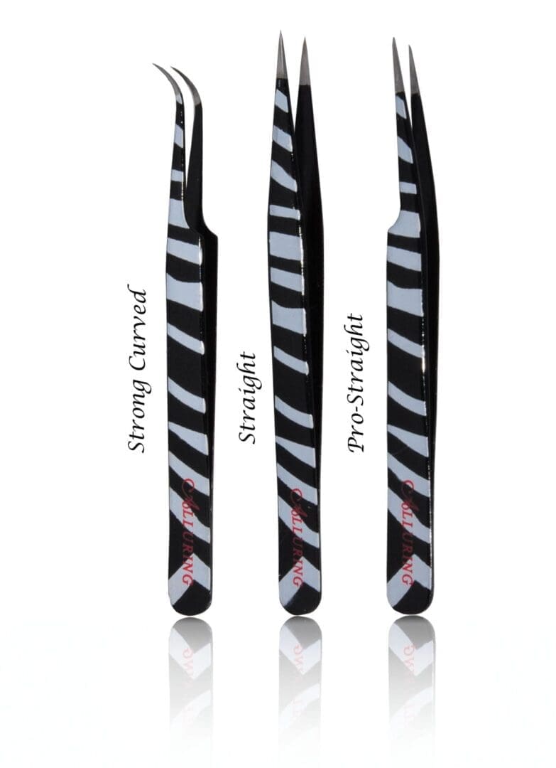 A set of three zebra-striped tweezers with different shapes.