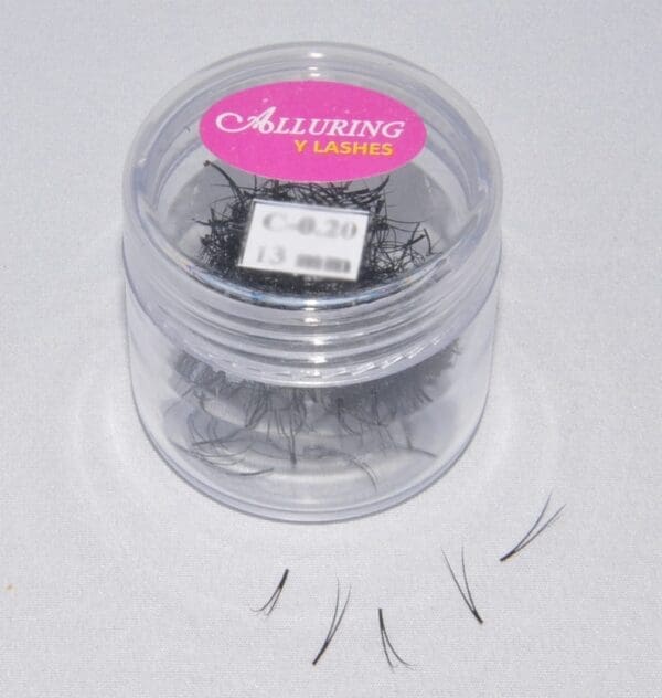 A container of false eyelashes in the shape of a heart.