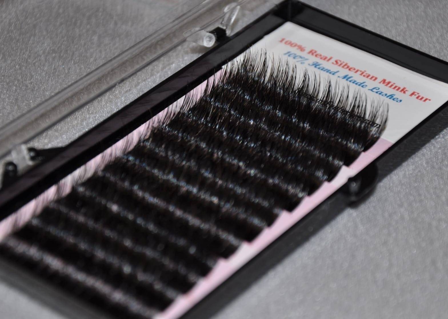 A close up of a box filled with black lashes