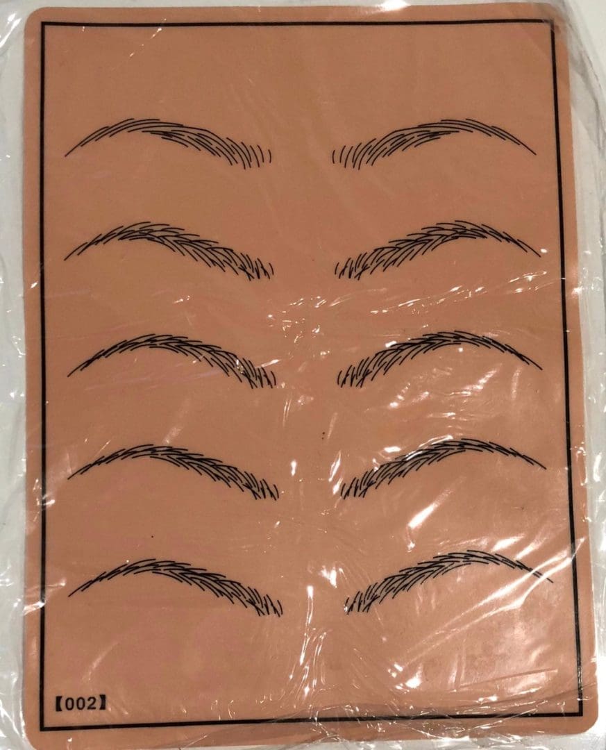 A plastic bag with some fake eyebrows on it