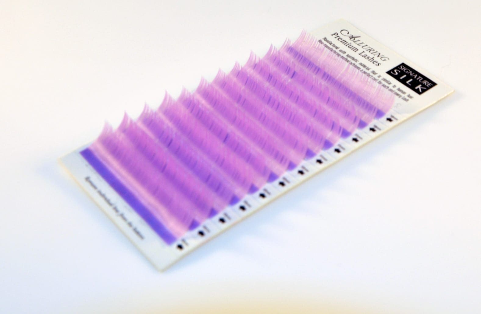 A purple strip of plastic is on the white surface.