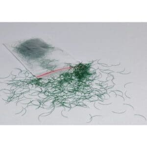 A green thread is laying on the floor
