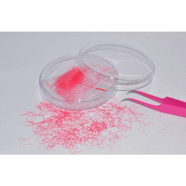 A pink object in a plastic container next to a fork.