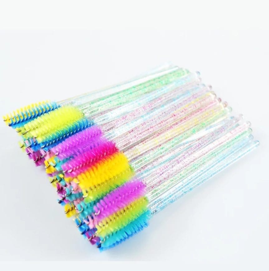 A bunch of toothbrushes are laying on the table