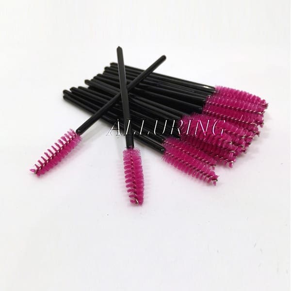 A bunch of pink and black mascara brushes