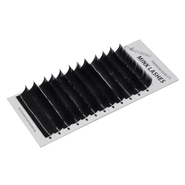 A black strip of eyelash extensions on top of a white card.