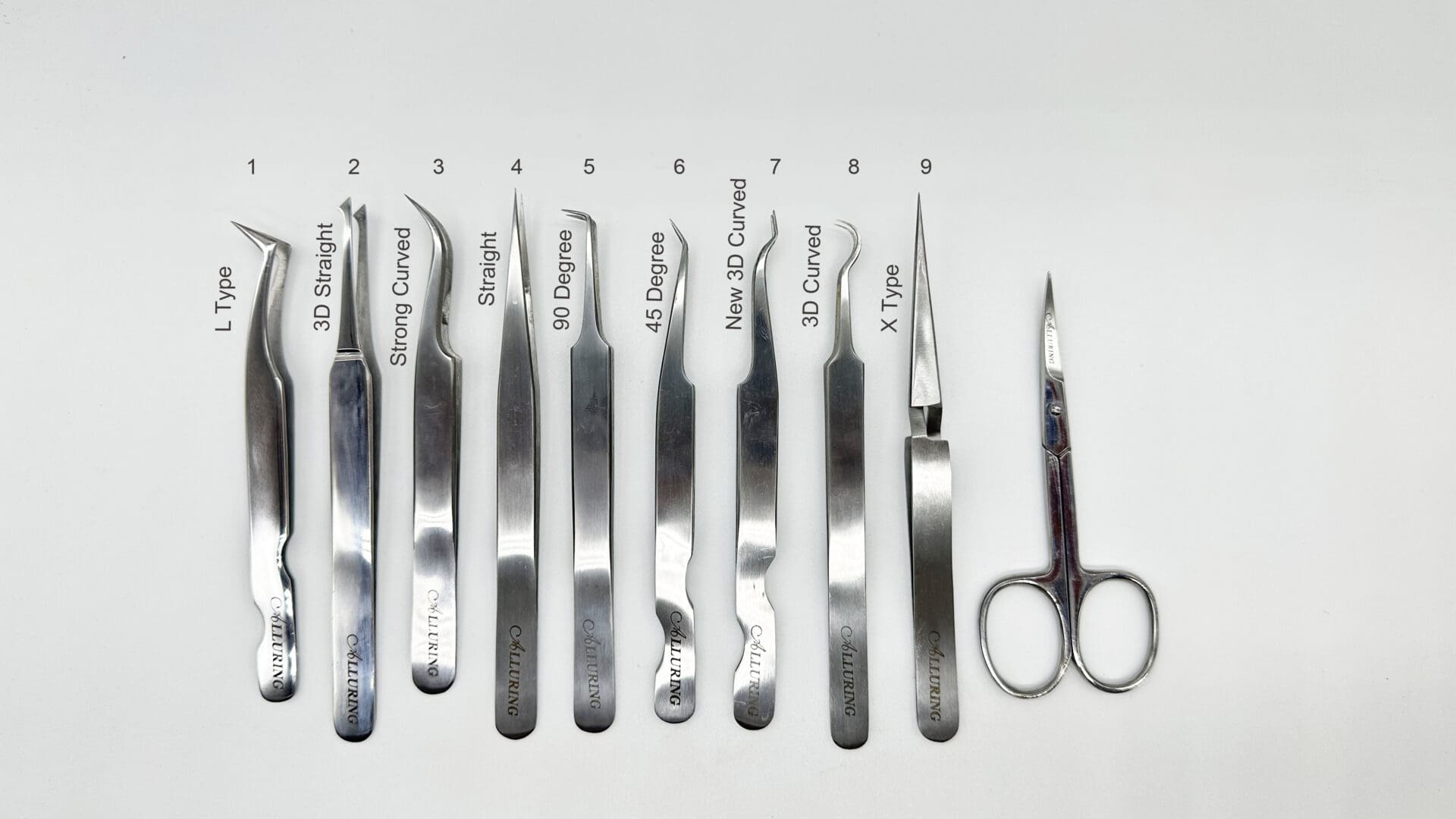 A white table with many pairs of scissors and some types