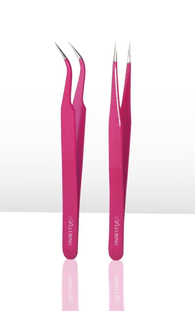 A pair of pink tweezers are sitting on top of a table.