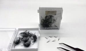 A box of hair and scissors on top of a table.