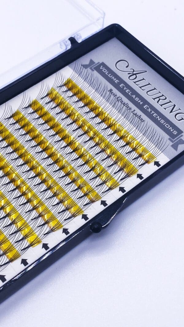A tray of yellow colored lashes in a case.