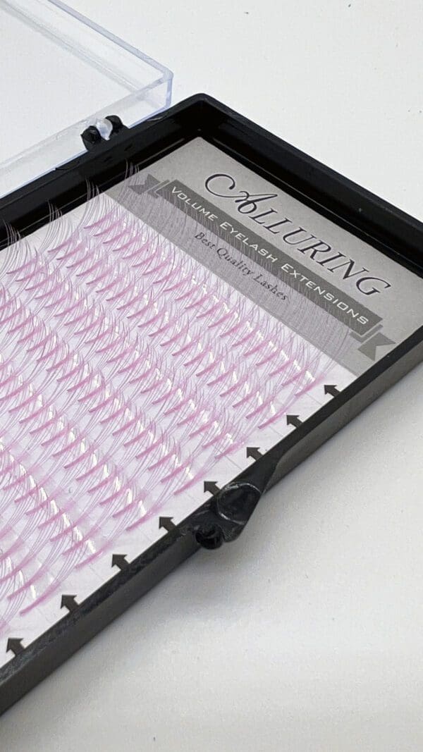 A tray of pink colored lashes in the middle of a picture.