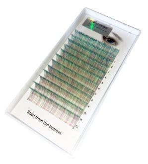 A tray of individual lashes with green and brown colored tips.