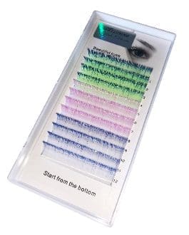 A tray of colored lashes with a black eye shadow brush.