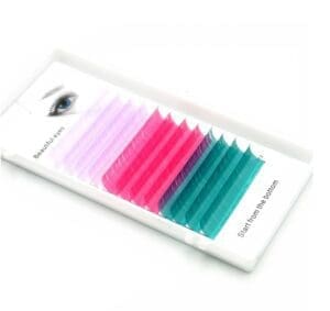 A tray of colored individual lashes in pink, blue and green.