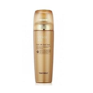 A bottle of skin care product with gold color.