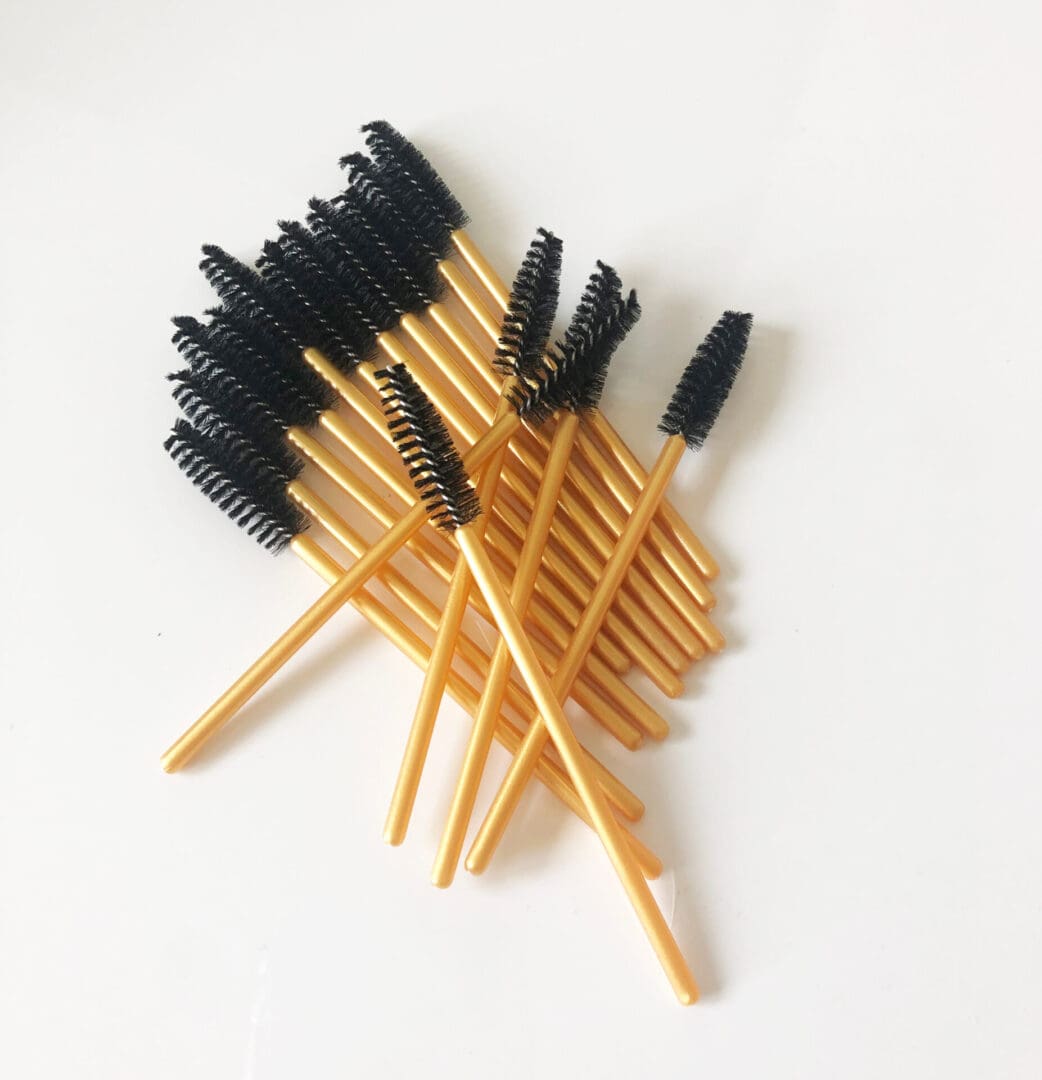 A bunch of black and yellow brushes on top of each other