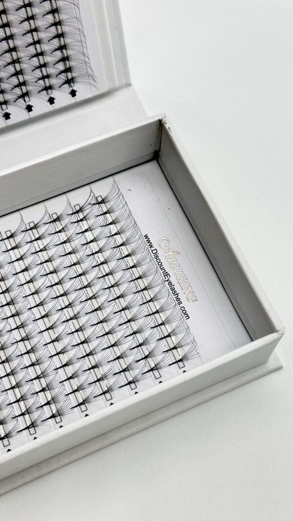 A box of individual lashes in the middle of its packaging.