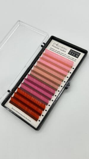 A box of colored lashes in pink and red.