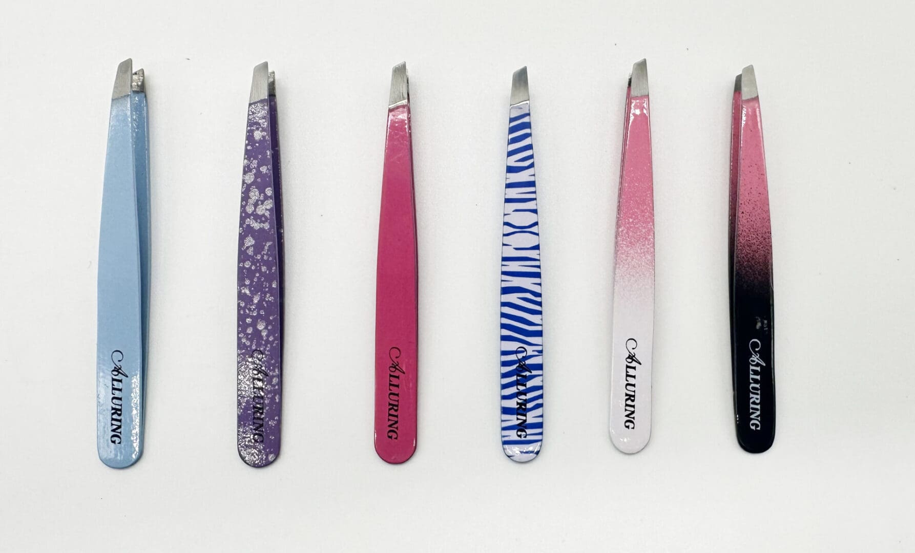 A row of different colored tweezers on top of each other.